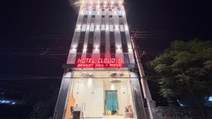 a tall building with a sign on it at night at Hotel Cloud 9 in Amritsar