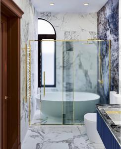 a bathroom with a glass shower and a tub at Rest Deluxe Hotel in Baku