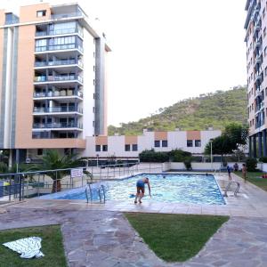 a person in a swimming pool in a building at Apartamentos Tamarindo Cala de Finestrat in Cala de Finestrat