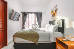 Un dormitorio con una cama con un lazo encima. en Nice Villa In Seminyak #YoNa, en Seminyak