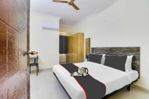 a bedroom with a bed with a tray on it at Super Collection O Rio Kondapur Near Rahavendra Colony in Hyderabad