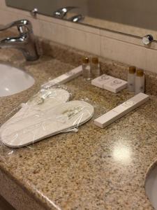a bathroom counter with two white shoes and a sink at Nairi Hotel Yerevan in Yerevan +39 photos