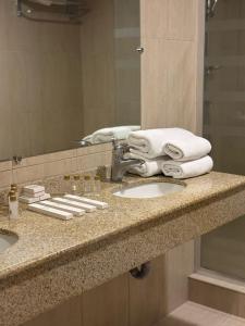 a bathroom counter with two sinks and a mirror at Nairi Hotel Yerevan in Yerevan