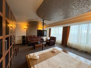 a hotel room with a bed and a couch at Nairi Hotel Yerevan in Yerevan