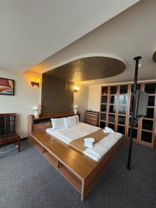 a bedroom with a large bed and a flat screen tv at Nairi Hotel Yerevan in Yerevan