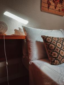 a bed with a pillow and a table with a light at FreeMood Campaegli in Campaegli +23 photos