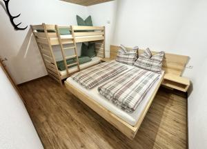 a bedroom with a wooden bunk bed with pillows at apart-gerlos in Gerlos