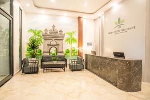 an office with a lobby with a reception desk and plants at The Green Hotel Vientiane in Vientiane +61 photos