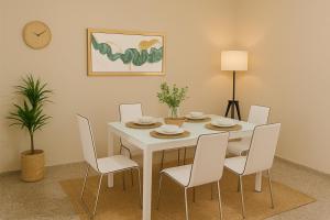 a dining room with a white table and chairs at Relaxing and Serene Guest Room in Cancino