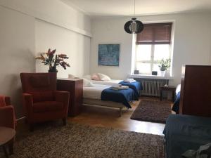 a living room with a bed and a chair at 1 Bedroom Apartment in Maceira