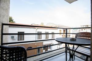 a balcony with a table and a view of a building at kutaisi hostel hub in Kutaisi