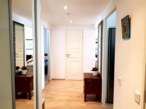 a hallway with a white door and a mirror at 1 Bedroom Apartment in Maceira