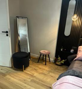 a dressing room with a stool and a mirror at GZP Residence Lugoj in Lugoj
