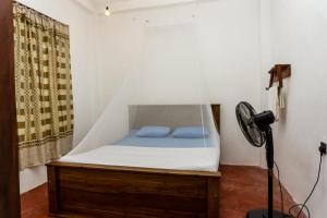 a bedroom with a bed with a canopy at cozy haven in Midigama
