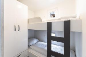 a bedroom with two bunk beds and a closet at Lovely HouseBoat Apartment Portorose in Portorož