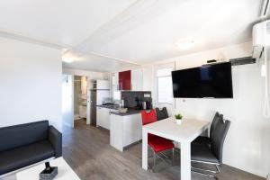 a kitchen and dining room with a table and chairs at Lovely HouseBoat Apartment Portorose in Portorož