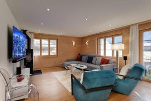 a living room with a couch and a tv at Charming Apartment in Gsteig in Gsteig