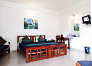 a bedroom with a bed and a tv in it at Hotel Lion Inn in Bandarawela