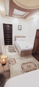 a bedroom with a bed and some rugs on the floor at pyramids dreams in Cairo