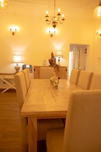 a dining room with a wooden table and chairs at Evergreen Hideout by Tequila Holidays in Kandangama