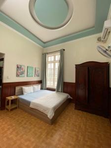 Postel nebo postele na pokoji v ubytování HOMESTAY 172A Ho Quy Ly BAI SAU + 9 fotografií