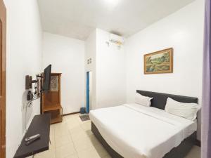 Postel nebo postele na pokoji v ubytování Pondok Wisata Istana XI