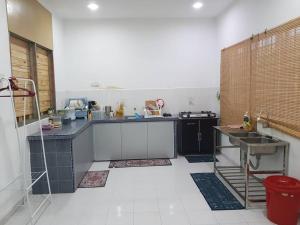 a kitchen with a counter and a sink in it at Alfateh MU5L1M Homestay in Sungai Petani