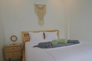 a bedroom with a white bed and a night stand at Luxury Villa With Private Pool Surrounded by Nature in Mantaak +35 photos