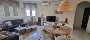 a living room with a table and a couch at Casa di Paddy in Ciudad Quesada