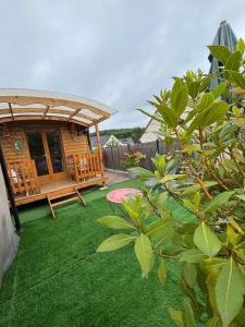 a gazebo in a yard with green grass at La Galipette, charmant chalet en Champagne in Fleury-la-Rivière