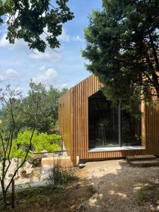 a small wooden house with a large window at Le Cigalou in Valaurie