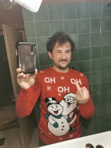 a man taking a picture of himself in a bathroom mirror at Le Cigalou in Valaurie