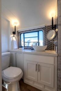 a bathroom with a white toilet and a sink at Prescott AZ Airstream Getaway One Block from Whiskey Row in Prescott