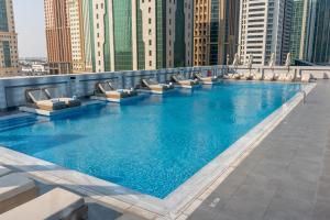 a large swimming pool on the roof of a building at Thirty Five Westbay Luxury Apartments in Doha