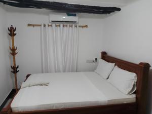 Ένα ή περισσότερα κρεβάτια σε δωμάτιο στο Kahawa apartment