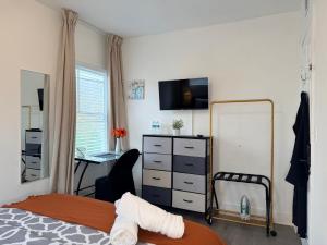 a bedroom with a bed and a dresser and a desk at Modern Room in Shared Apartment Near NYC in Englewood
