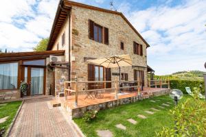 an external view of a stone house with a patio at I Vigneti del Chianti in Barberino di Val dʼElsa
