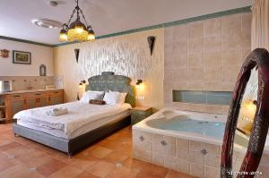 a bedroom with a bed and a tub at סיקרט נס ספא in Had Nes +41 photos