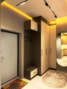 a room with a closet and a door with a rug at Downtown Loft in Dushanbe