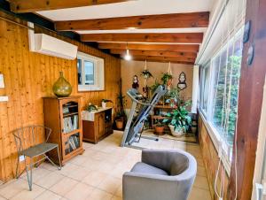 a room with a gym with a chair and a treadmill at Maison 3 étoiles climatisée, jardin, parking, proche centre et thermes in Dax +39 photos