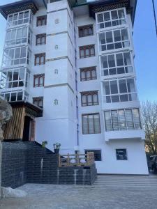 a large white building with windows on the side at Hotel GaiaYuel in Thimphu