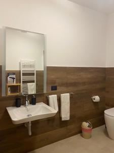 a bathroom with a sink and a toilet and a mirror at Ma Home in Cinisi