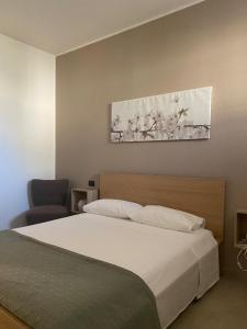 a bedroom with a bed and a painting on the wall at Ma Home in Cinisi +17 photos