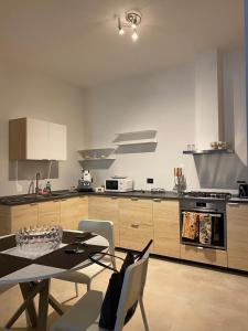 a kitchen with a table and a table and chairs at Ma Home in Cinisi