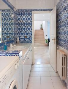 a kitchen with blue and white walls and a staircase at Villa Souad - havre de paix et charme tunisien aux portes de Tunis in La Marsa +42 photos