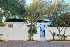 a white garage with trees in front of it at Villa Souad - havre de paix et charme tunisien aux portes de Tunis in La Marsa