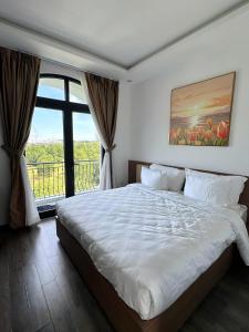 Ένα ή περισσότερα κρεβάτια σε δωμάτιο στο Rose Hill Hotel Phú Quốc