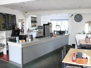a coffee shop with a counter and a table at Byards Leap Lodges in Welbourn