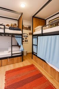 a room with two bunk beds and a rug at Hostel El Cascabel in Granada