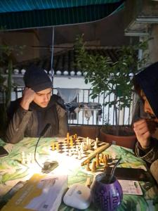 a man playing a game of chess on a table at Hostel El Cascabel in Granada